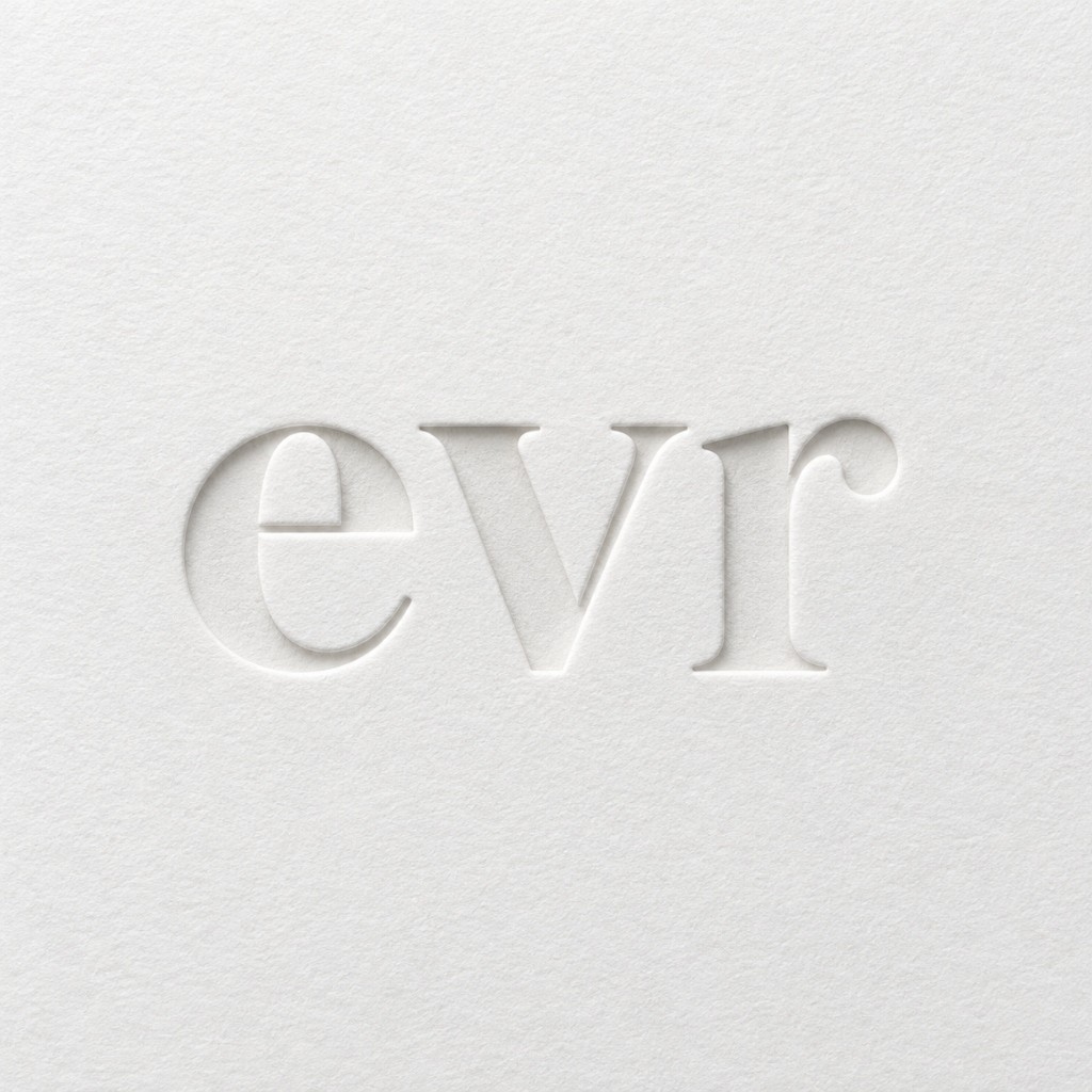 The evr mark blind-embossed on white card