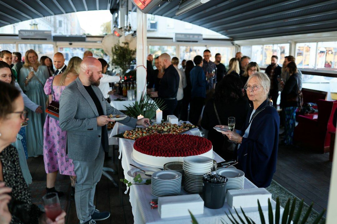 Guests around a dessert table at a corporate event