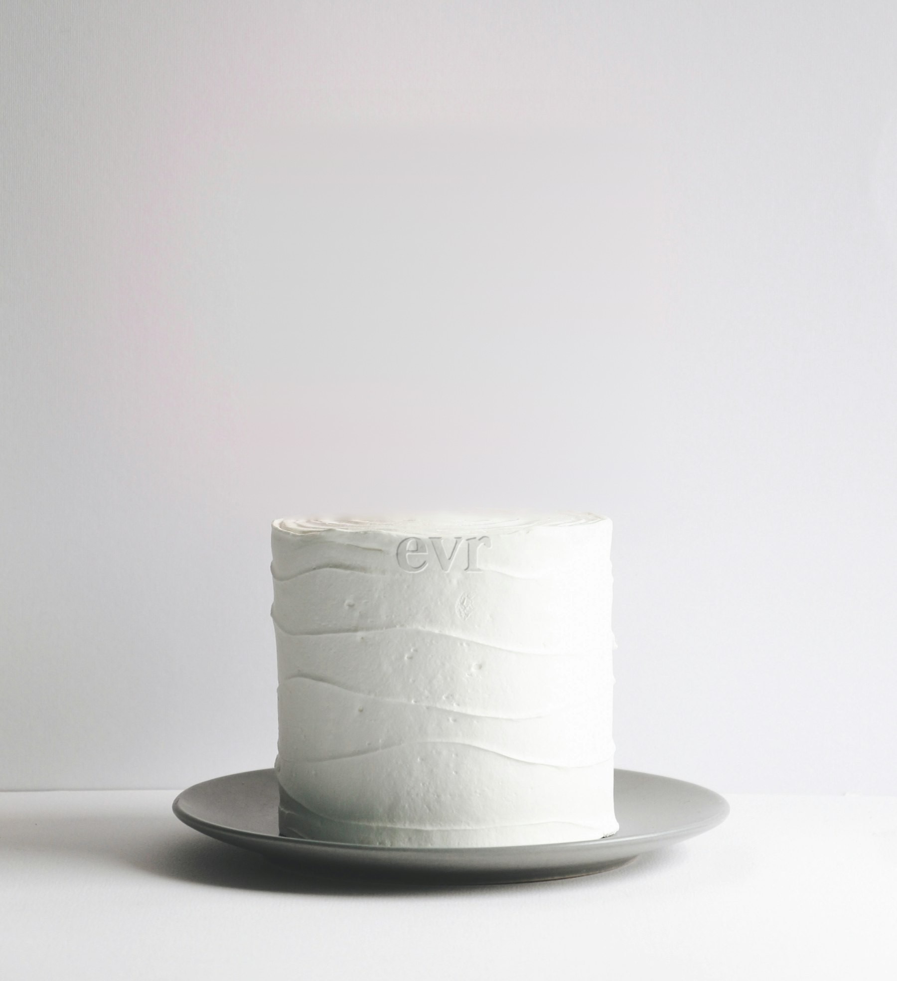 Minimal white cake embossed with the evr logo